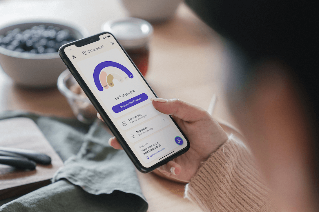 The Osteoboost app in a person's hand showing how the app encourages people.