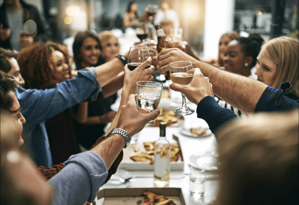 Group of people drinking a beer in a pub. Drinking adds risk to people with low bone density such as osteoporosis and osteopenia.